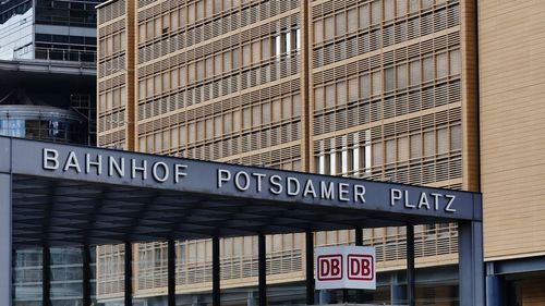 Low angle view of road sign against building in city