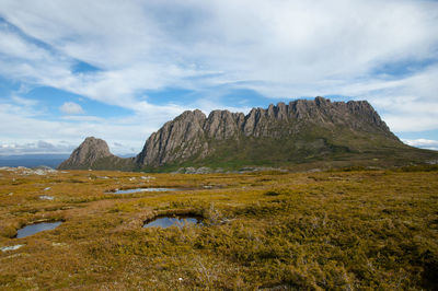 Scenic view of mountains against cloudy sky