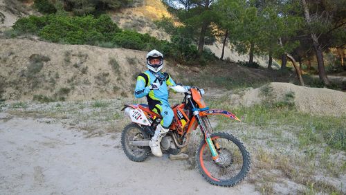 Man riding bicycle on dirt road