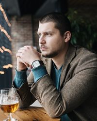 Close-up of businessman having beer at table in restaurant