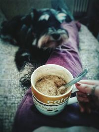 Close-up of hand holding coffee cup