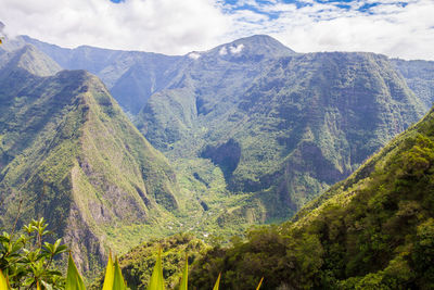 High angle shot of lush landscape against clouds