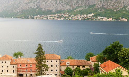 Impressive aerial view to the part of kotor bay - red roofs, boats, sea and the town of dobrota