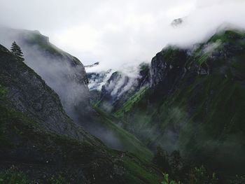 Scenic view of waterfall against sky