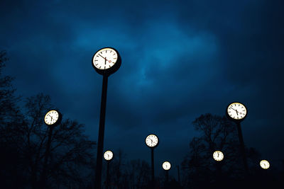 Low angle view of illuminated street light against sky