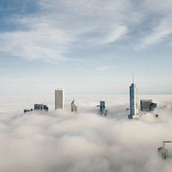 View of cityscape covered with clouds