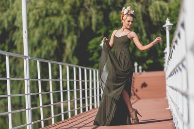 Woman standing on footbridge