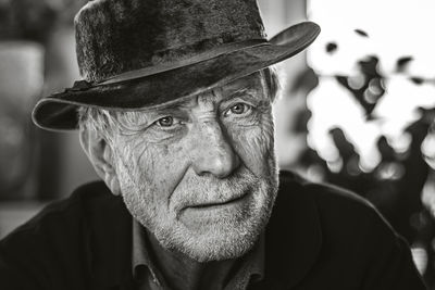 Close-up portrait of senior man wearing hat