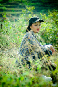 Young woman looking away on field