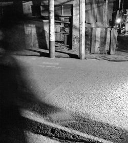 Empty road amidst buildings in city at night