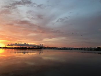 Scenic view of lake against sky during sunset
