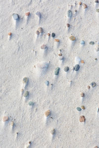 High angle view of pebbles on sand