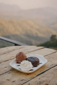 Chocolate cake with ice cream on table