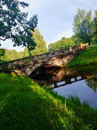 Arch bridge over river against sky