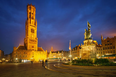 Belfry tower and grote markt square in bruges, belgium on dusk in twilight