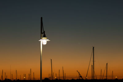 Street lamp against sky during sunset