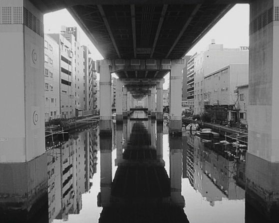 architecture, built structure, transportation, building exterior, water, mode of transport, bridge - man made structure, nautical vessel, connection, reflection, canal, river, city, sky, waterfront, boat, building, outdoors, travel, day