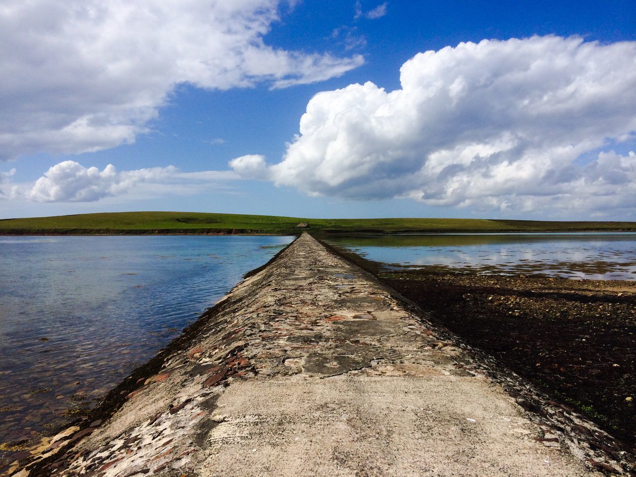 water, sky, tranquil scene, the way forward, tranquility, cloud - sky, cloud, sea, scenics, nature, beauty in nature, diminishing perspective, cloudy, blue, lake, horizon over water, day, idyllic, grass, pier