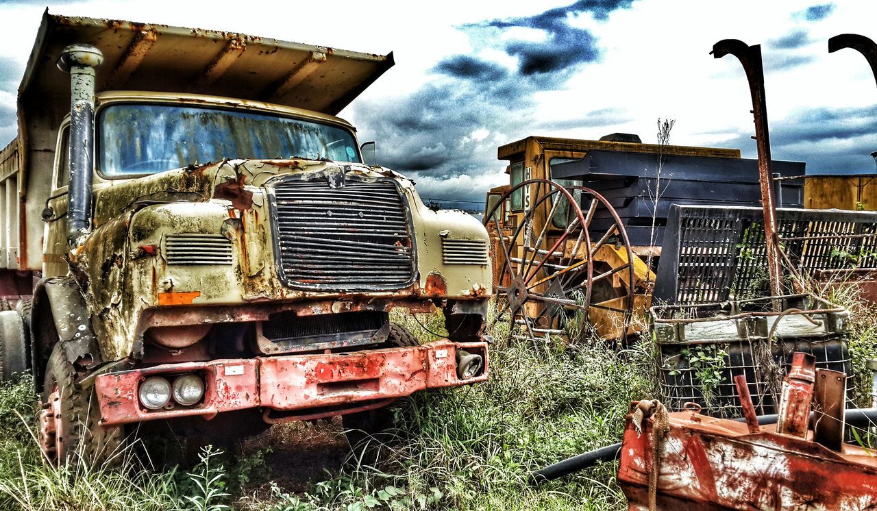 transportation, mode of transport, land vehicle, abandoned, sky, obsolete, damaged, car, run-down, old, deterioration, rusty, cloud - sky, building exterior, stationary, parked, built structure, outdoors, day, tractor