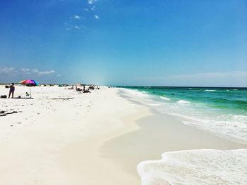 People on beach against sky