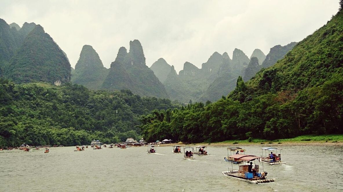 mountain, large group of people, tree, leisure activity, lifestyles, vacations, men, person, sky, tourist, tourism, scenics, water, tranquil scene, beauty in nature, travel, tranquility, nature, travel destinations