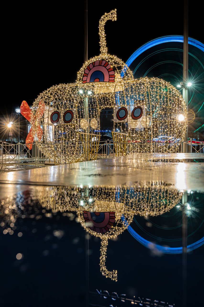 night, illuminated, reflection, christmas lights, architecture, christmas decoration, water, celebration, decoration, no people, built structure, lighting equipment, amusement park, building exterior, nature, holiday, amusement park ride, arts culture and entertainment, travel destinations, lighting, outdoors, light, sky, christmas, city, motion