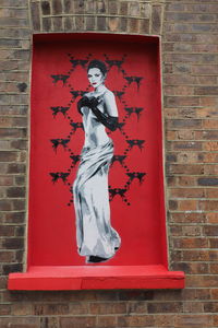 Statue against brick wall