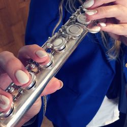 Close-up of hands playing on flute