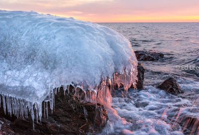 Panoramic view of frozen sea against sky during sunset