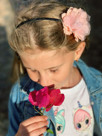 High angle view of girl smelling flowers