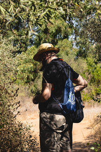 Rear view of man walking in forest