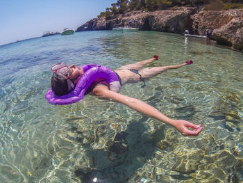 Young woman with swimming in sea