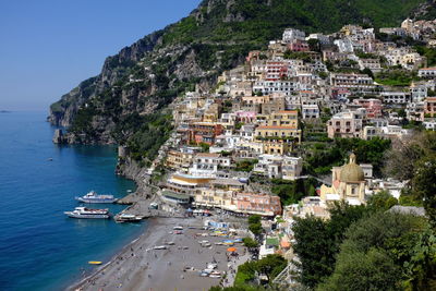 Houses in sea shore at positano against clear sky