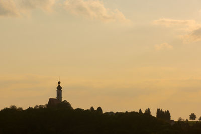 Silhouette of building against sky during sunset