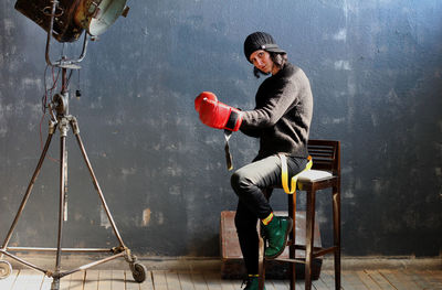 Side view of man sitting on seat