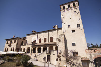 Low angle view of old building against clear blue sky