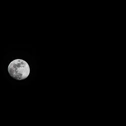 Low angle view of moon against clear sky at night