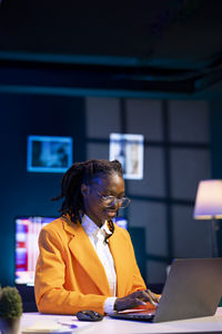 Young woman using laptop at office