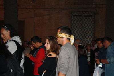 Group of people standing in city at night