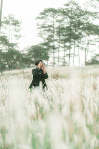 Portrait of man with his camera in the middle of white reeds