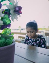 Close-up of girl looking at table