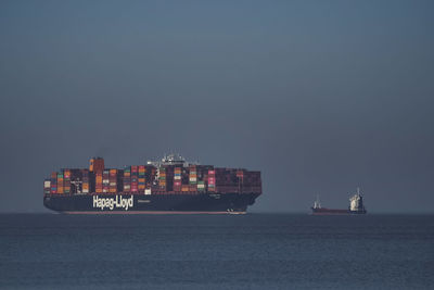 Ship sailing in sea against clear sky