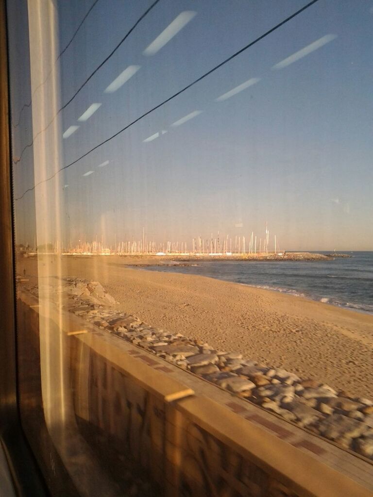 water, sea, horizon over water, sky, beach, window, transparent, scenics, indoors, shore, nature, glass - material, transportation, clear sky, reflection, tranquility, tranquil scene, built structure, no people, beauty in nature