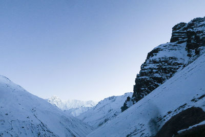 Scenic view of snowcapped mountains against clear sky