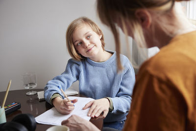 Mother helping daughter with homework