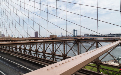 Steel cables of bridge with buildings in backgrounds