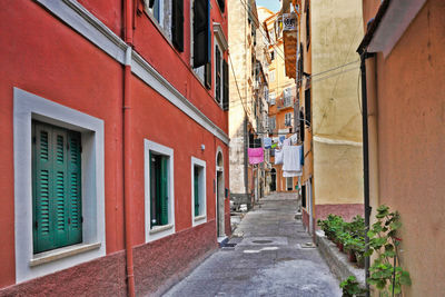 Footpath amidst buildings in city