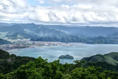 Scenic view of lake and mountains against sky