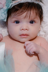 Close-up portrait of cute baby on bed