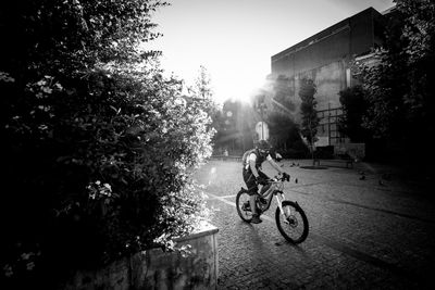 Man riding bicycle on street in city